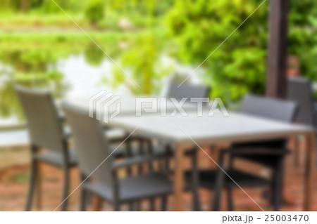 Blurred classic table with four chairs and river Blurred classic table with four chairs and river 25003470