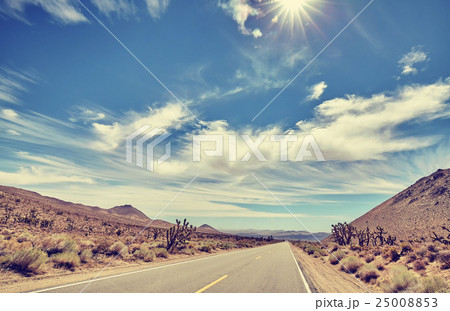 Vintage toned desert road against sun. Vintage toned desert road against sun. 25008853