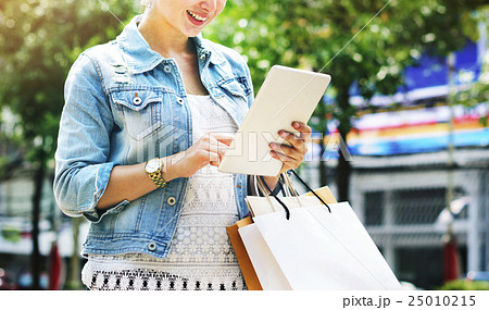 Woman Shopping Outdoor Using Tablet Concept 25010215