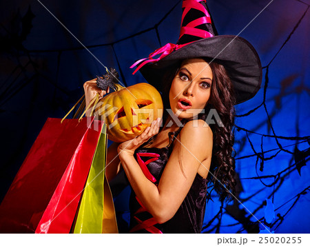 Woman holding Halloween shopping bag. 25020255