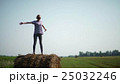 Pretty girl is standing on haystacks 25032246