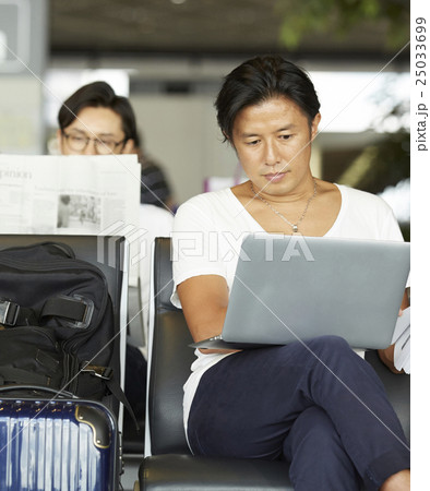 空港で出発を待つ男性 25033699