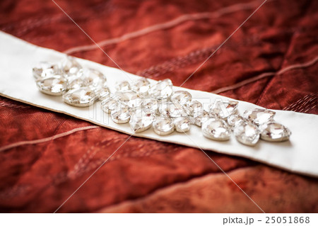 Wedding belt decorated with jewelry on red sofa 25051868