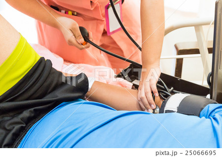 Closeup of nurse taking patient blood pressure Closeup of nurse taking patient blood pressure 25066695