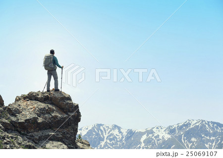 successful woman backpacker hiking  mountain peak 25069107