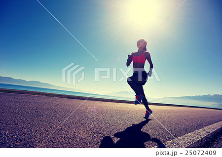 young woman runner running on sunrise seaside young woman runner running on sunrise seaside 25072409