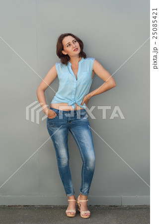 Beautiful young woman posing near a gray wall. Beautiful young woman posing near a gray wall. 25085421