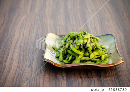 Soybean put in a plate placed on a wooden table 25088780