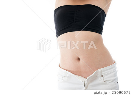 お腹のくびれを強調するポーズをとる女性 ダイエットイメージの写真素材