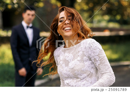 Woman with sparkling broad smile shakes her hair  25091789