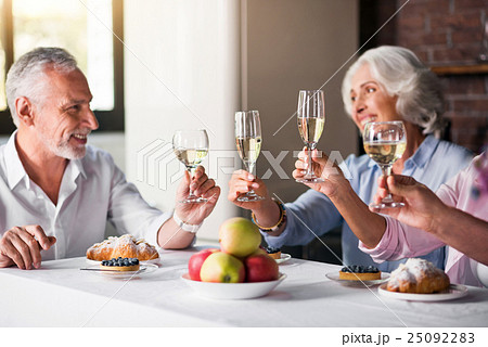 Four glasses of wine being raised at the house 25092283
