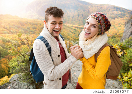Beautiful couple in autumn nature against colorful 25093077