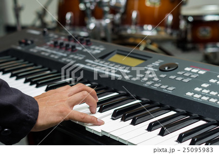 Closeup hands playing the keyboard or piano on brand music instrument background, music concept 25095983