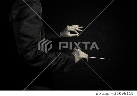 Orchestra conductor hands, Musician director holding stick on dark background Orchestra conductor hands, Musician director holding stick on dark background 25096119