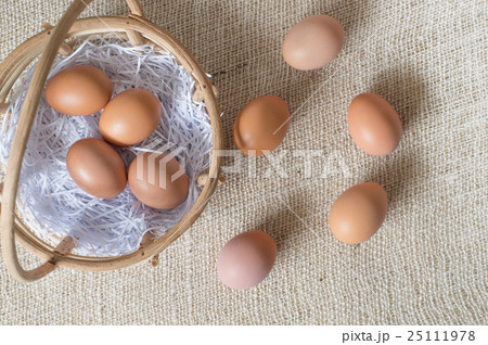 Eggs in bamboo basket on jute sack 25111978