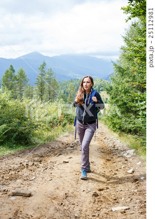 Young backpacker woman enjoying mountain trip 25112981