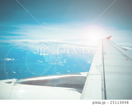 Lens flare and view of jet plane wing Lens flare and view of jet plane wing 25113048