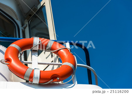 Orange lifebuoy on a white yacht 25116200