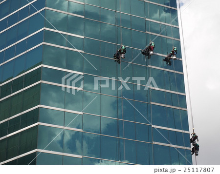man cleaning glass building man cleaning glass building 25117807