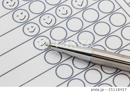Evaluation paper with hand drawn smileys 25118457