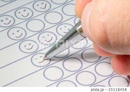 Hand filling out performance evaluation sheet 25118458