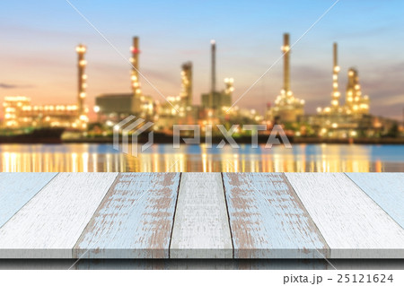Wood with blurred Oil refinery plant at dusk. Wood with blurred Oil refinery plant at dusk. 25121624