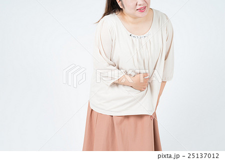 お腹が痛む太った女性の写真素材
