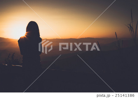 Single adult woman silhouette and sunset Single adult woman silhouette and sunset 25141386