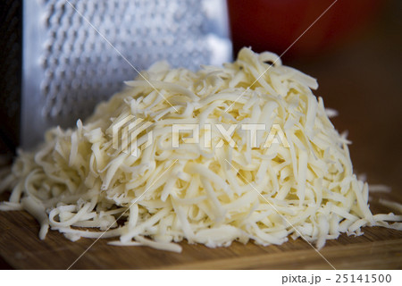 Shredded mozzarella cheese on a cutting board  25141500