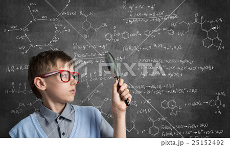 Curious school boy with magnifier 25152492