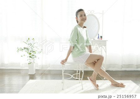 鏡台の前の笑顔の女性 25156957