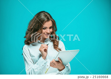 The smiling young business woman with pen and 25160668
