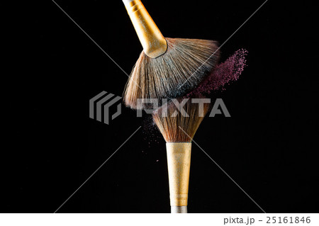 Make-up brushes with pink powder isolated on black 25161846