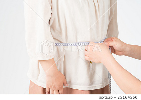 ウエストを測ってもらう太った女性 25164560