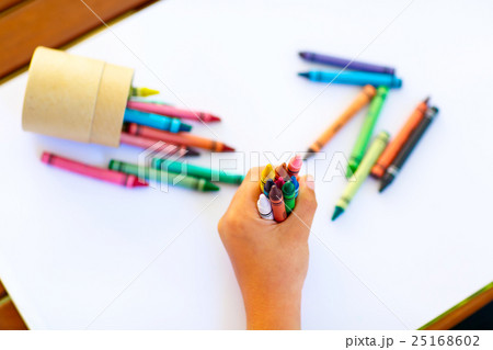 child's hands with lots of colorful wax crayons child's hands with lots of colorful wax crayons 25168602