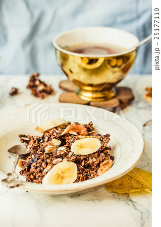 Homemade chocolate granola with banana, peanut Homemade chocolate granola with banana, peanut 25177119
