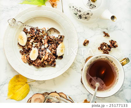 Homemade chocolate granola with banana, peanut Homemade chocolate granola with banana, peanut 25177133