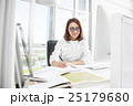 Smiling asian businesswoman working at office desk 25179680