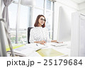 Smiling asian businesswoman working at office desk 25179684