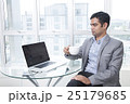 Businessman using laptop holding coffee cup  25179685