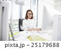 Smiling asian businesswoman working at office desk 25179688