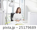 Smiling asian businesswoman working at office desk 25179689
