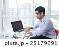 Focused businessman working at laptop in office 25179691