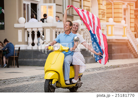 Couple riding scooter and smiling. Couple riding scooter and smiling. 25181770