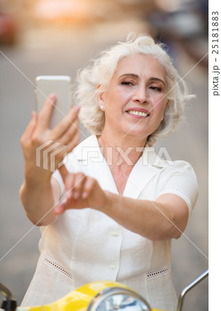 Adult woman touches phone. 25181883