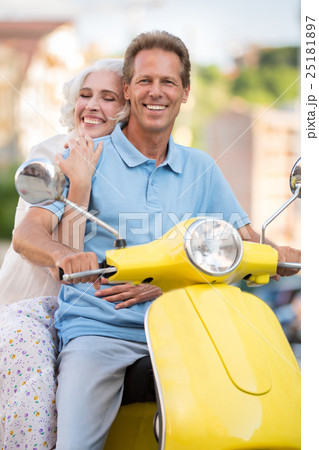 Woman hugs man on scooter. Woman hugs man on scooter. 25181897