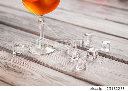 Ice cubes near a wineglass. 25182273
