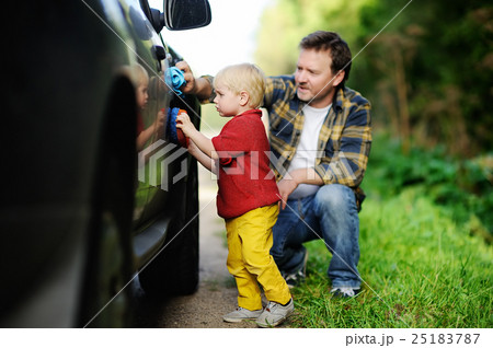 Father with his toddler son washing car together Father with his toddler son washing car together 25183787