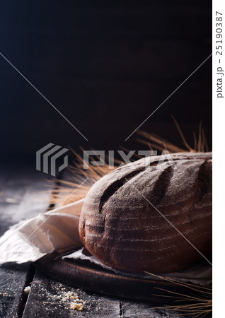 wheat and bread on a wooden table wheat and bread on a wooden table 25190387