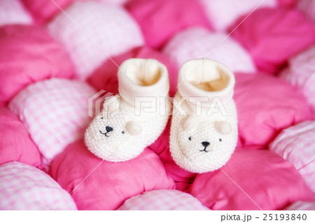 Cute white baby booties on pink blanket. Pregnancy 25193840